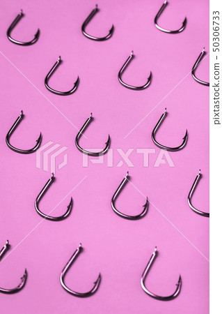 lots of fishing hooks on pink background  50306733