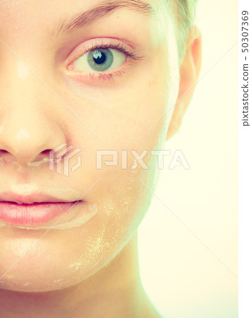 Close up woman in facial peel off mask. 50307369