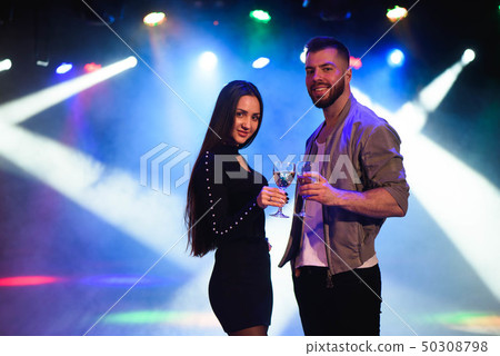 Image of happy young couple having fun at disco. Image of happy young couple having fun at disco. 50308798