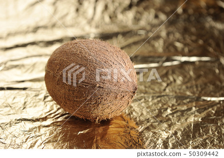 whole coconut on golden whole coconut on golden 50309442