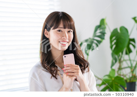 Young woman, smartphone, businesswoman, office casual Young woman, smartphone, businesswoman, office casual 50310940