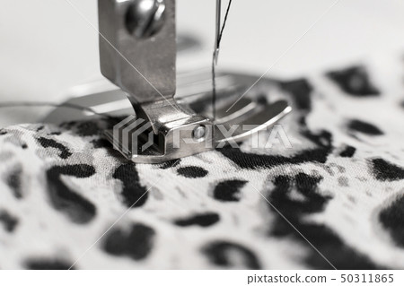 Sewing machine with fabric and thread, closeup 50311865