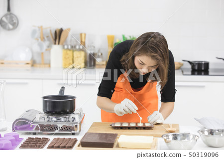 Woman making chocolate Woman making chocolate 50319096