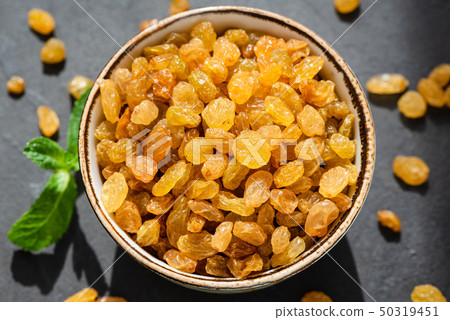Golden Raisins In Bowl Closeup Golden Raisins In Bowl Closeup 50319451