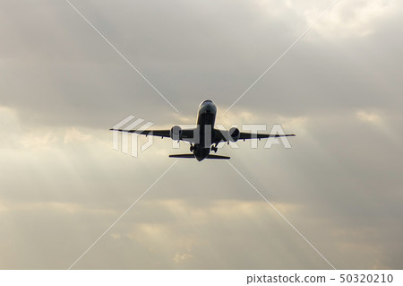 Passenger airplane taking-off in sunset 50320210