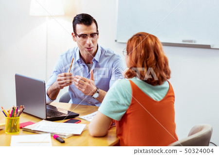 Handsome good looking man talking to his student Handsome good looking man talking to his student 50324004