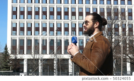 A TV journalist is reporting from the street A TV journalist is reporting from the street 50324055