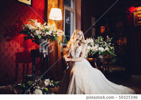 Sensuality blondie bride sitting on chair in Sensuality blondie bride sitting on chair in 50325396