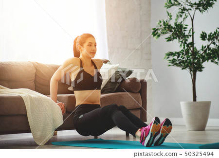 young woman doing fitness and sports at home . young woman doing fitness and sports at home . 50325494