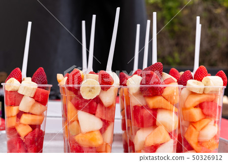 Mixed Fruit Salad arranged in plastic cups on a market stall. Mixed Fruit Salad arranged in plastic cups on a market stall. 50326912