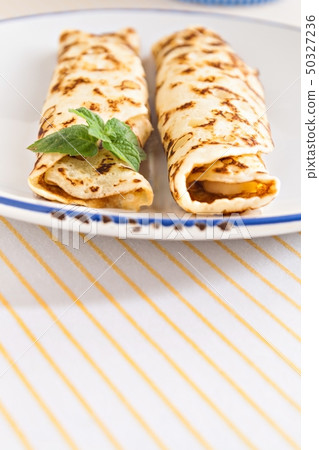 thin pancakes rolled crepes mint on a plate with 50327236