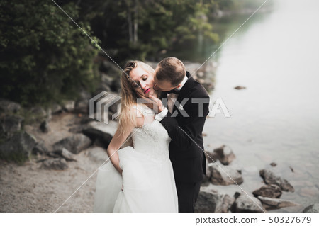 Sensual portrait of a young wedding couple. Outdoor 50327679