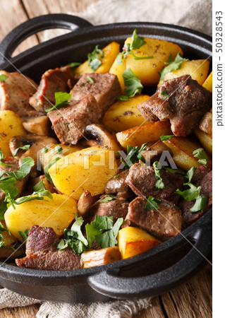 fried pork with potatoes and mushrooms closeup in 50328543