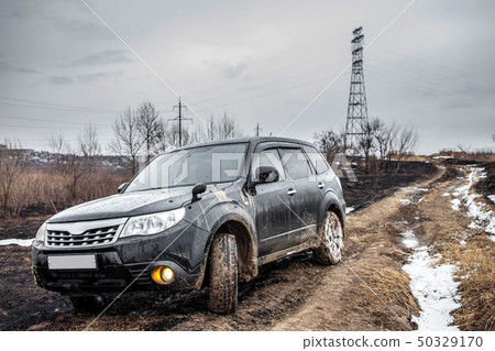 Crossover on dirt road with deep mud Crossover on dirt road with deep mud 50329170