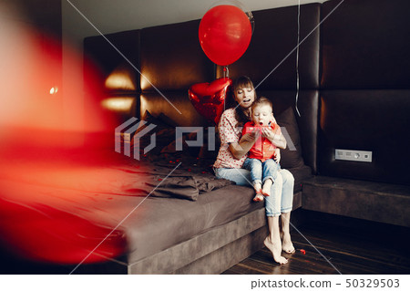 Elegant mother with little son in a bed Elegant mother with little son in a bed 50329503