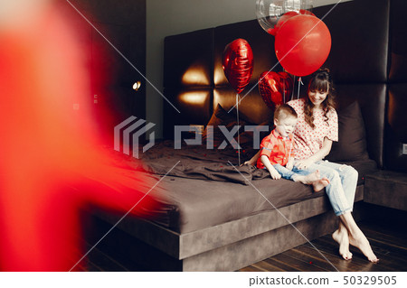 Elegant mother with little son in a bed 50329505