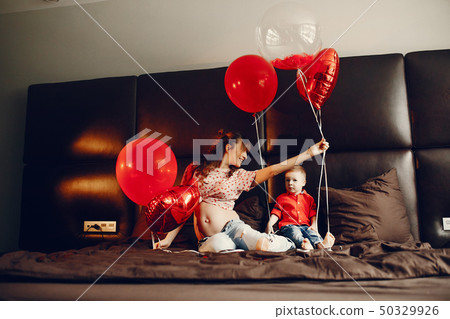 Elegant mother with little son in a bed 50329926