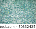 Closeup surface water in a blue swimming pool 50332425