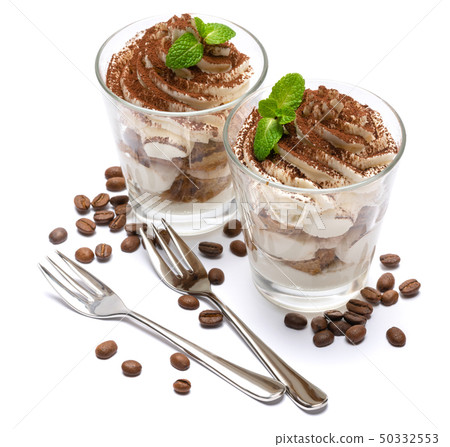 two portions Classic tiramisu dessert in a glass isolated on a white background 50332553