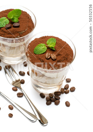 two portions Classic tiramisu dessert in a glass isolated on a white background 50332556