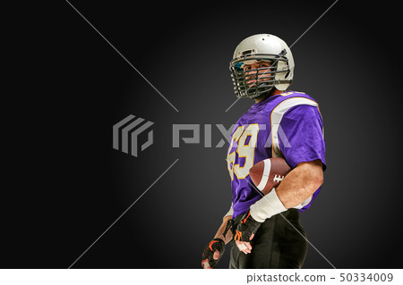 American football player in action with ball American football player in action with ball 50334009