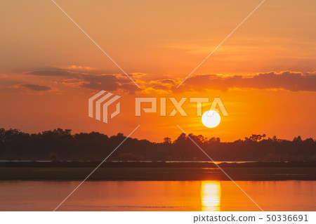 Sunset in the lake. beautiful sunset behind the 50336691