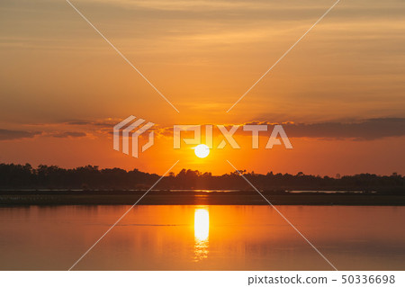Sunset in the lake. beautiful sunset behind the 50336698