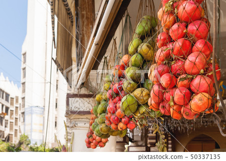 Mango and pomegranates in woven bags. Mango and pomegranates in woven bags. 50337135