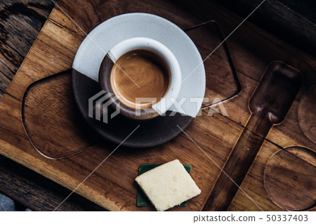 Espresso coffee in ceramic cup on wooden table Espresso coffee in ceramic cup on wooden table 50337403
