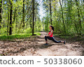 Fitness woman doing leg stretching in summer forest 50338060