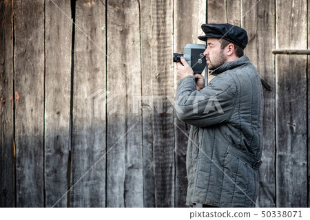 Cameraman with retro film camera. Concept - cinema 50338071