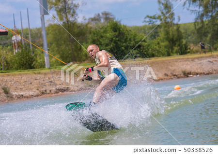 Man study wakeboarding on a blue lake 50338526