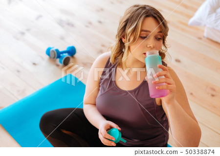Nice young woman holding a bottle with water 50338874