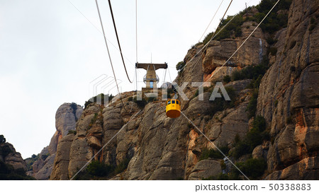Yellow cable car in the Aeri de Montserrat rise to de Montserrat Abbey near Barcelona, Spain Yellow cable car in the Aeri de Montserrat rise to de Montserrat Abbey near Barcelona, Spain 50338883
