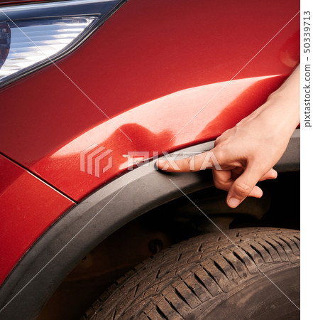 Finger point at car scratch 50339713