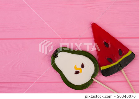 Large tasty lollipops in a shape of fruits. 50340076