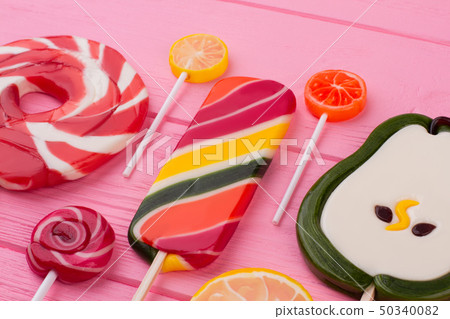 Assorted lollipops on color background. 50340082