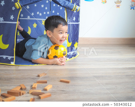 Happy little boy having fun with a play tent at 50343012