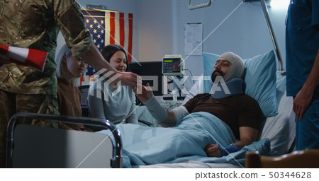 Injured soldier receives badge of honor in hospital room 50344628