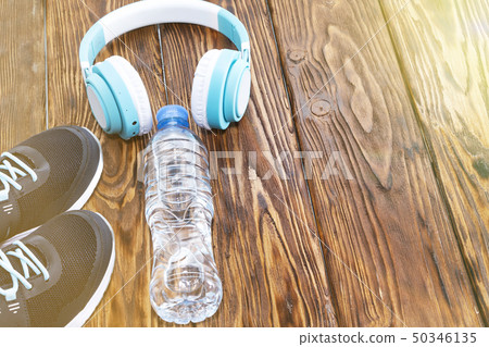 Sports equipment. Sneakers, water and headphones 50346135