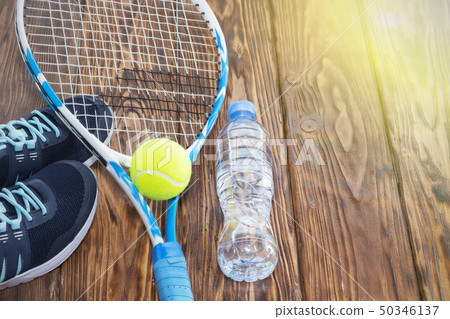 Tennis on a dark background. sneakers, rocket, 50346137
