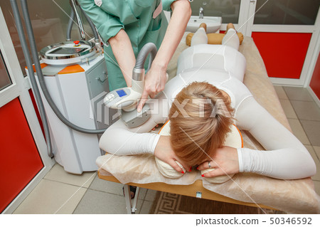 Woman having anti-cellulite lpg massage treatment 50346592