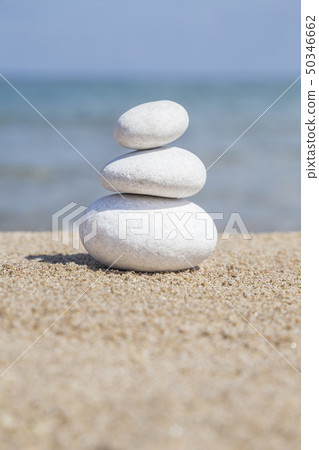 stack of pebble stones on balance on sandy beach stack of pebble stones on balance on sandy beach 50346662