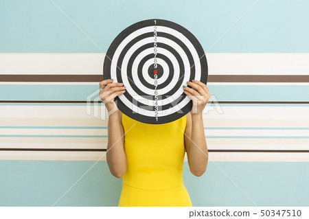 Goals concept with young woman holding target on Goals concept with young woman holding target on 50347510