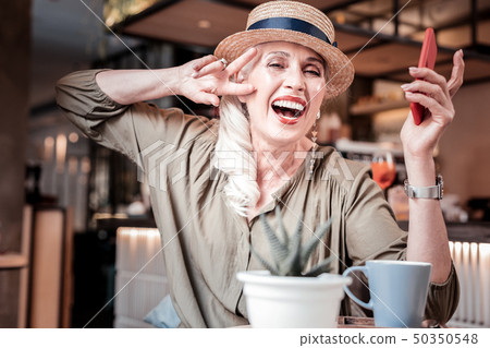 Laughing long-haired old lady with fashionable outfit 50350548
