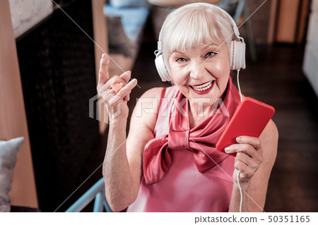 Beaming good-looking senior woman with bright makeup Beaming good-looking senior woman with bright makeup 50351165