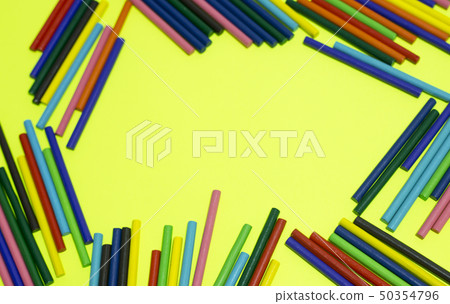 many colorful wood sticks lays yellow background. many colorful wood sticks lays yellow background. 50354796