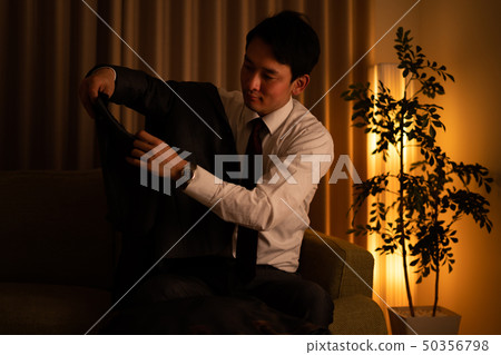 A man in a suit that came home 50356798