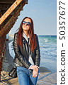 Beautiful young redhead woman staying at the beach 50357677