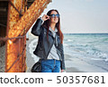 Beautiful young redhead woman staying at the beach 50357681